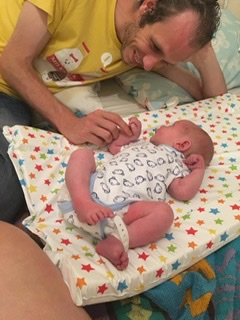 Daddy playing with Robbie on his changing mat when he was just a few days old.