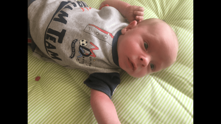 Baby Robbie just a few days old with his eyes wide open, taking everything in.