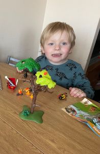 Robbie smiling at his Dad showing off his completed Dick on call building