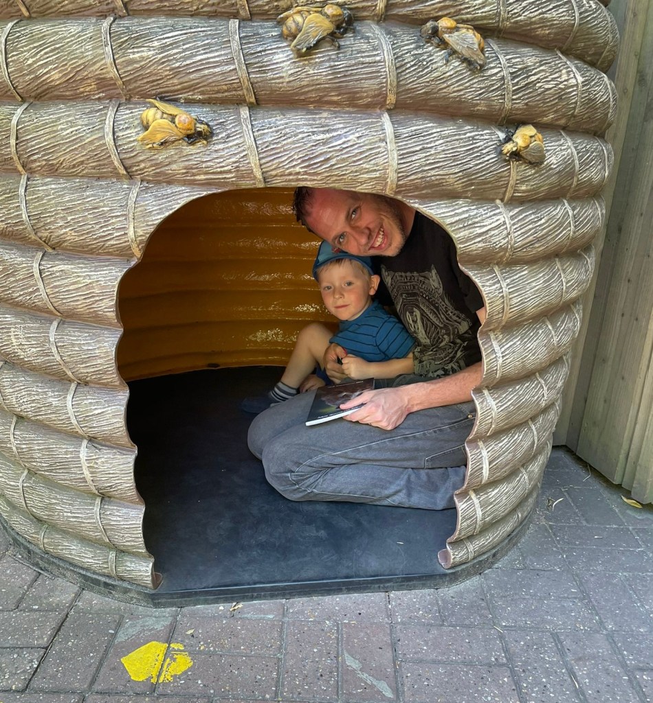 Robbie and Dad hiding in a bee hive at Colchester Zoo.
